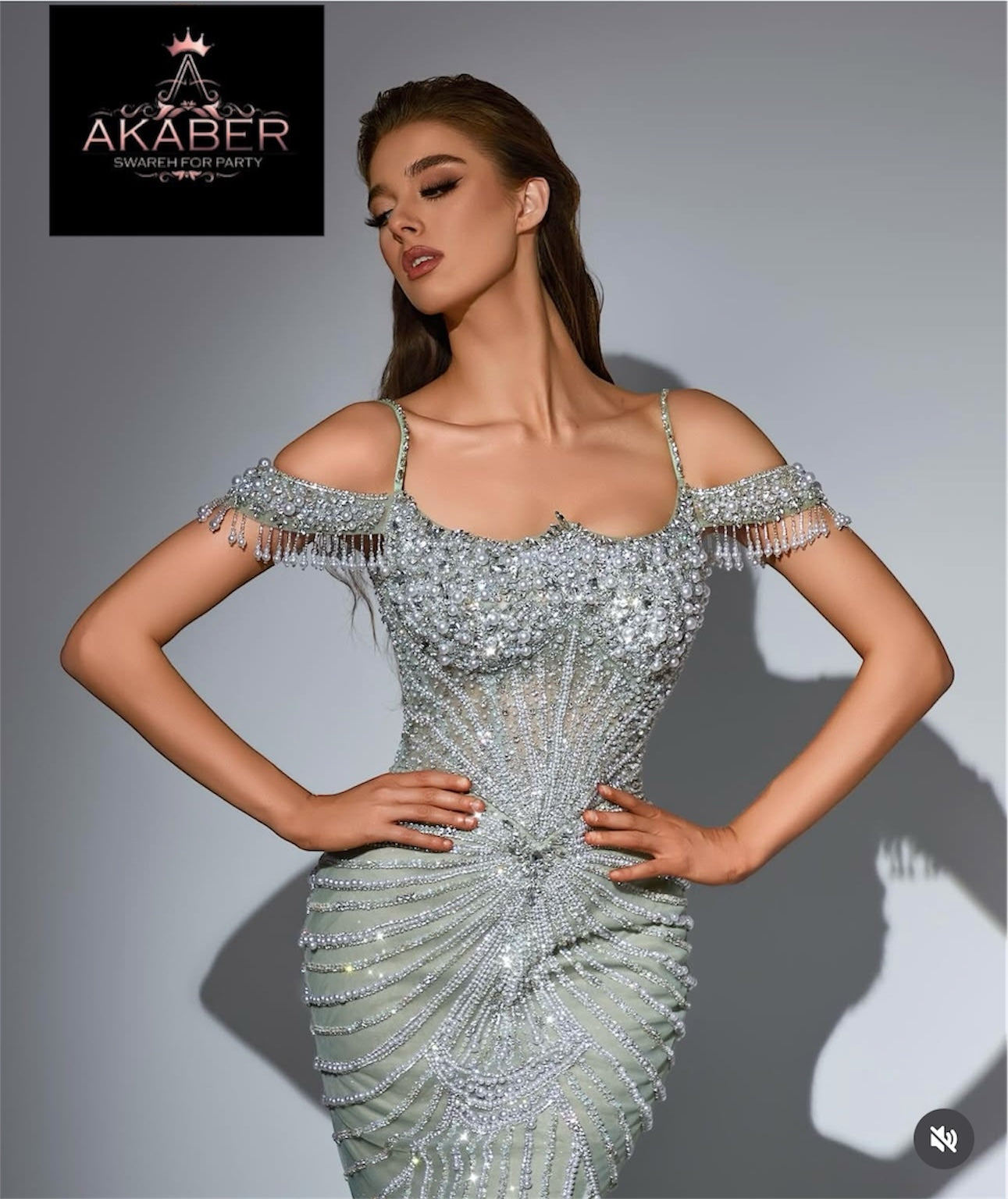 Embellished dress with off-shoulder design.