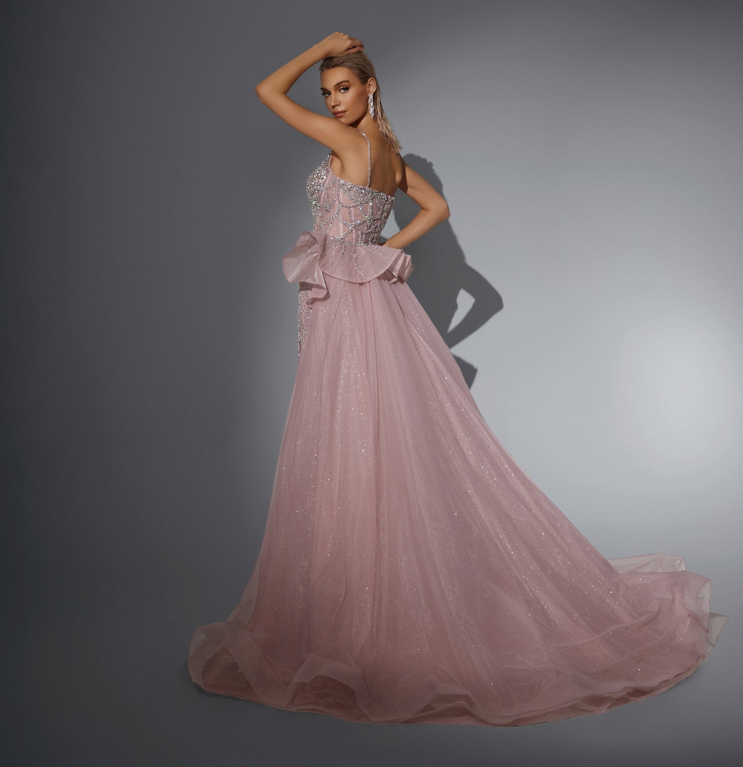 Luxurious dress adorned with gemstones, featuring a long train at the back.”