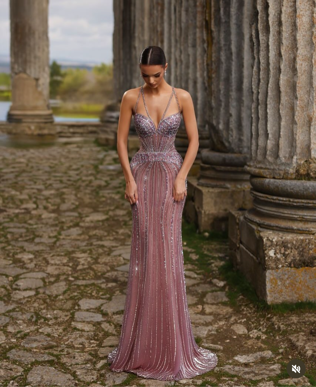 “Elegant and luxurious dress adorned with gemstones and crystals, featuring attractive colors.”
