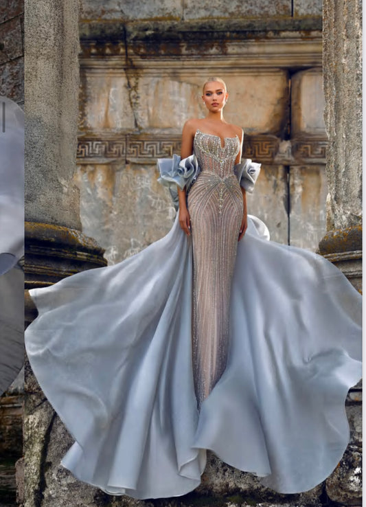 Luxurious strapless dress with two pieces on the arms connected by a long organza scarf.”