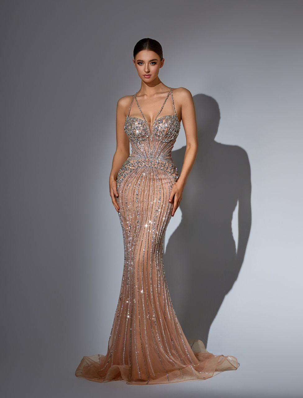“Elegant and luxurious dress adorned with gemstones and crystals, featuring attractive colors.”