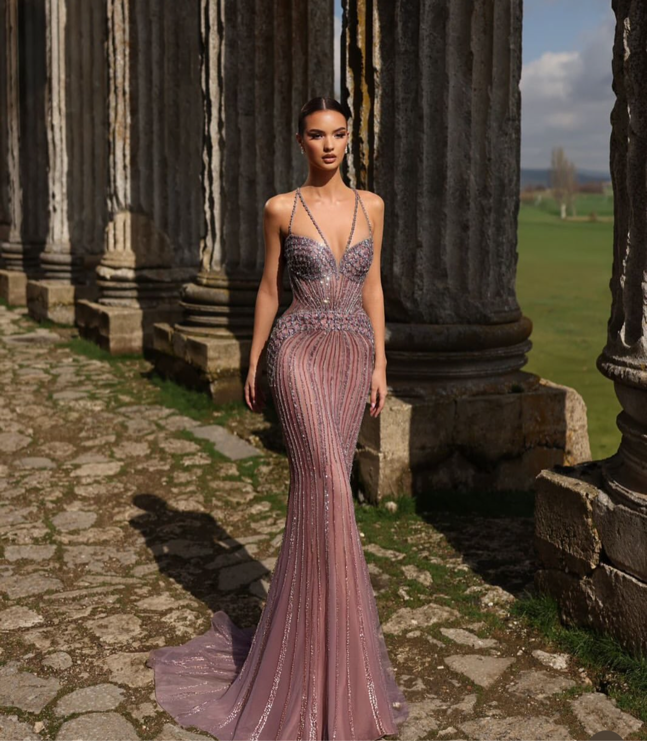 “Elegant and luxurious dress adorned with gemstones and crystals, featuring attractive colors.”