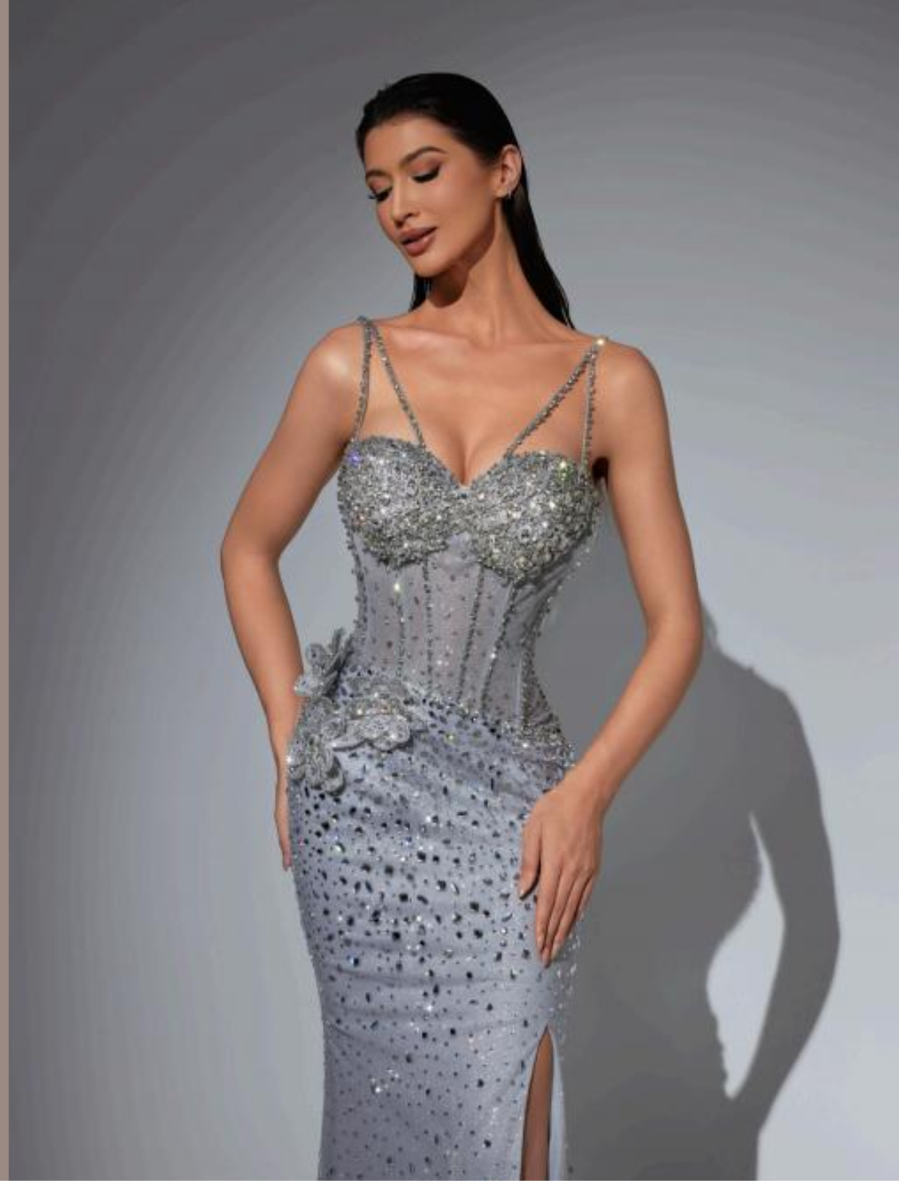“Luxury dress with crystal embroidery on the chest and a floral detail at the waist.