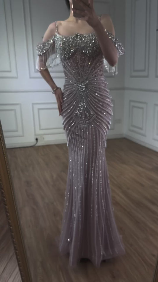 An elegant party dress with dazzling, stone-embellished off-shoulder sleeves.